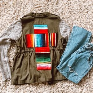 Olive green vest with serape cross.